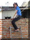 Cousin climbing over wall to sister's house